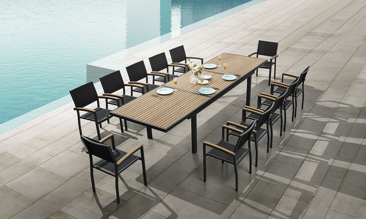 Outdoor dining set with table and chairs by a poolside
